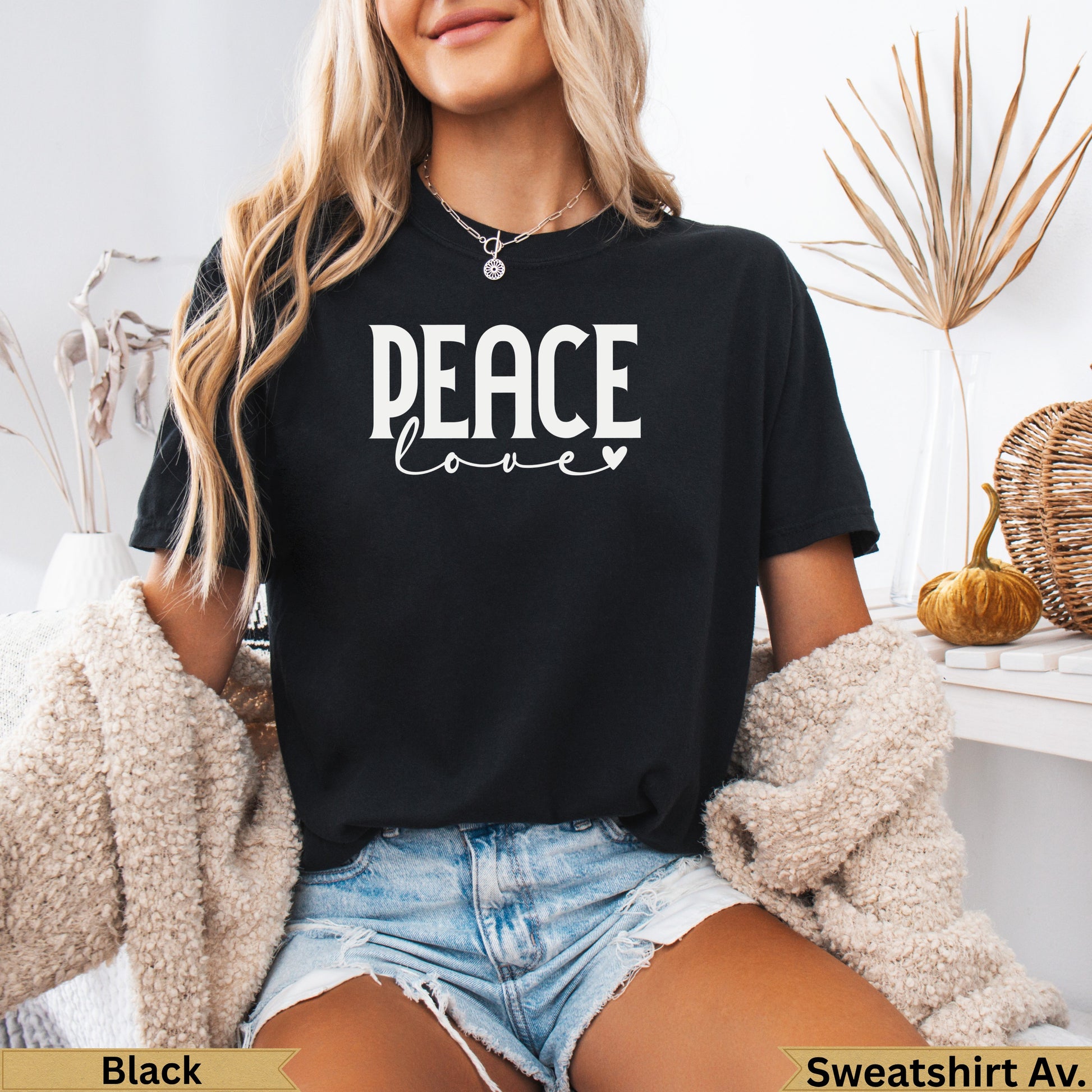Black t-shirt with "PEACE love" graphic, worn by a woman.