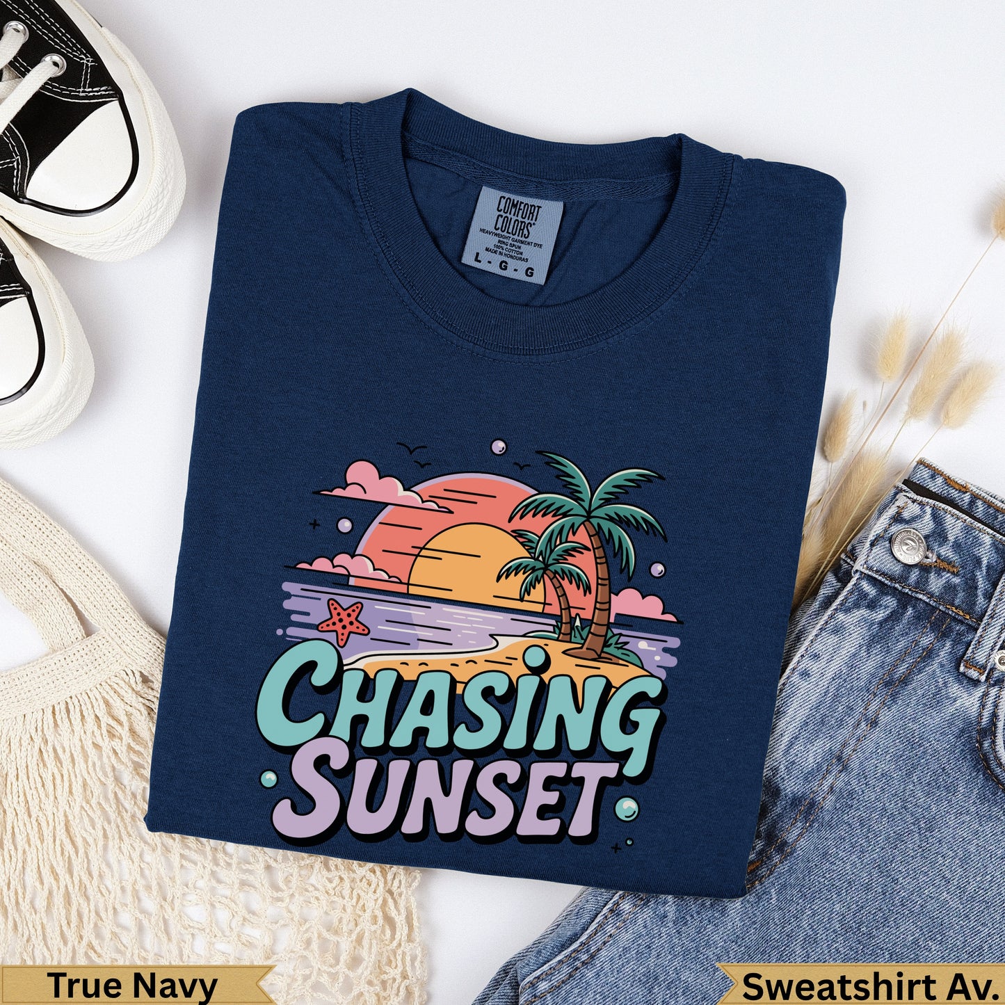 Navy sweatshirt with "Chasing Sunset" text and tropical beach graphic.