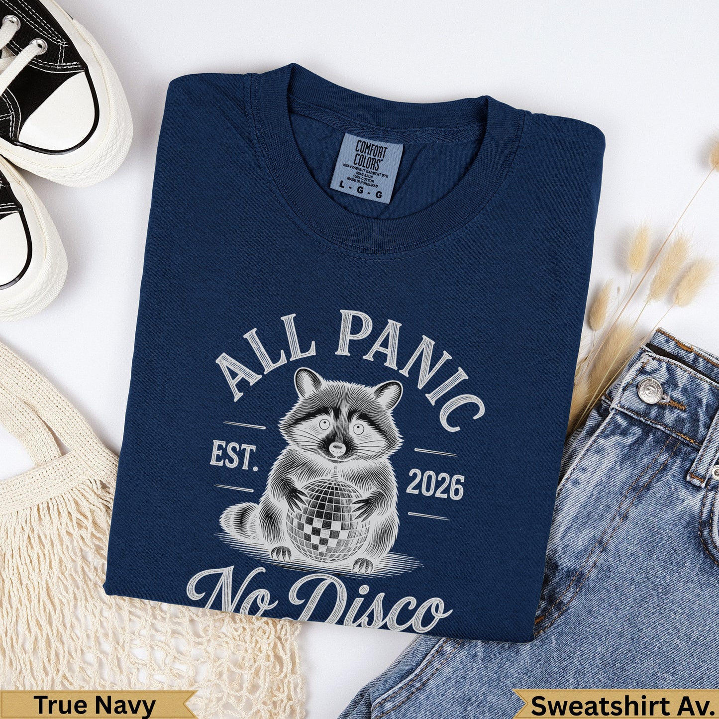 Navy sweatshirt with raccoon and disco ball graphic, text "All Panic Est. 2026 No Disco".