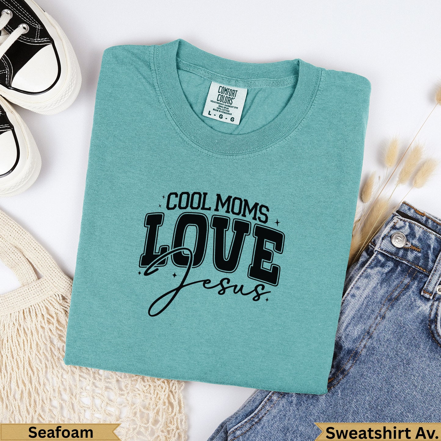 Teal Comfort Colors sweatshirt with "COOL MOMS LOVE Jesus" graphic.
