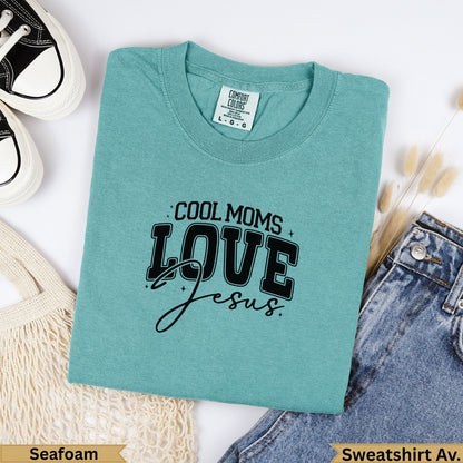 Teal Comfort Colors sweatshirt with "COOL MOMS LOVE Jesus" graphic.
