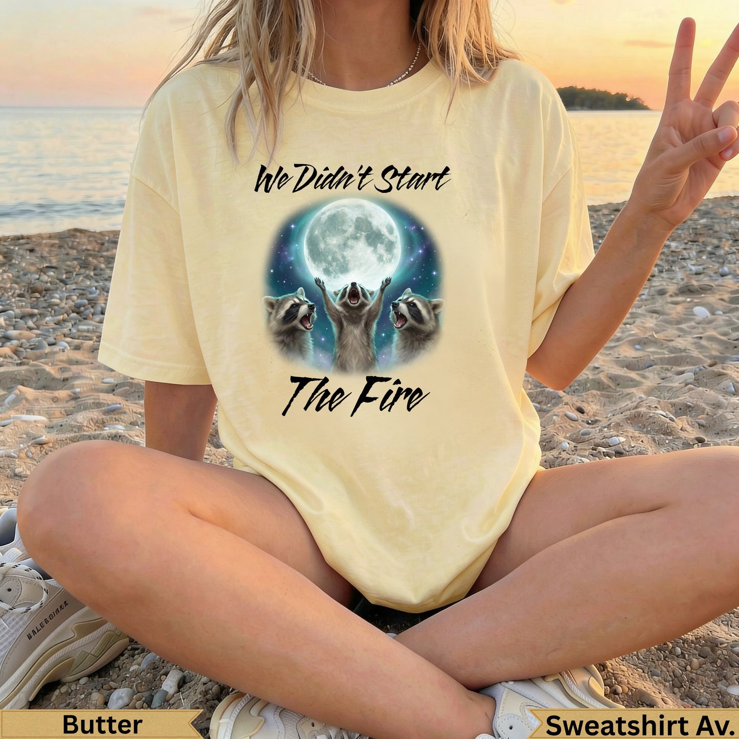 Yellow t-shirt with raccoons and moon graphic reading "We Didn't Start The Fire".