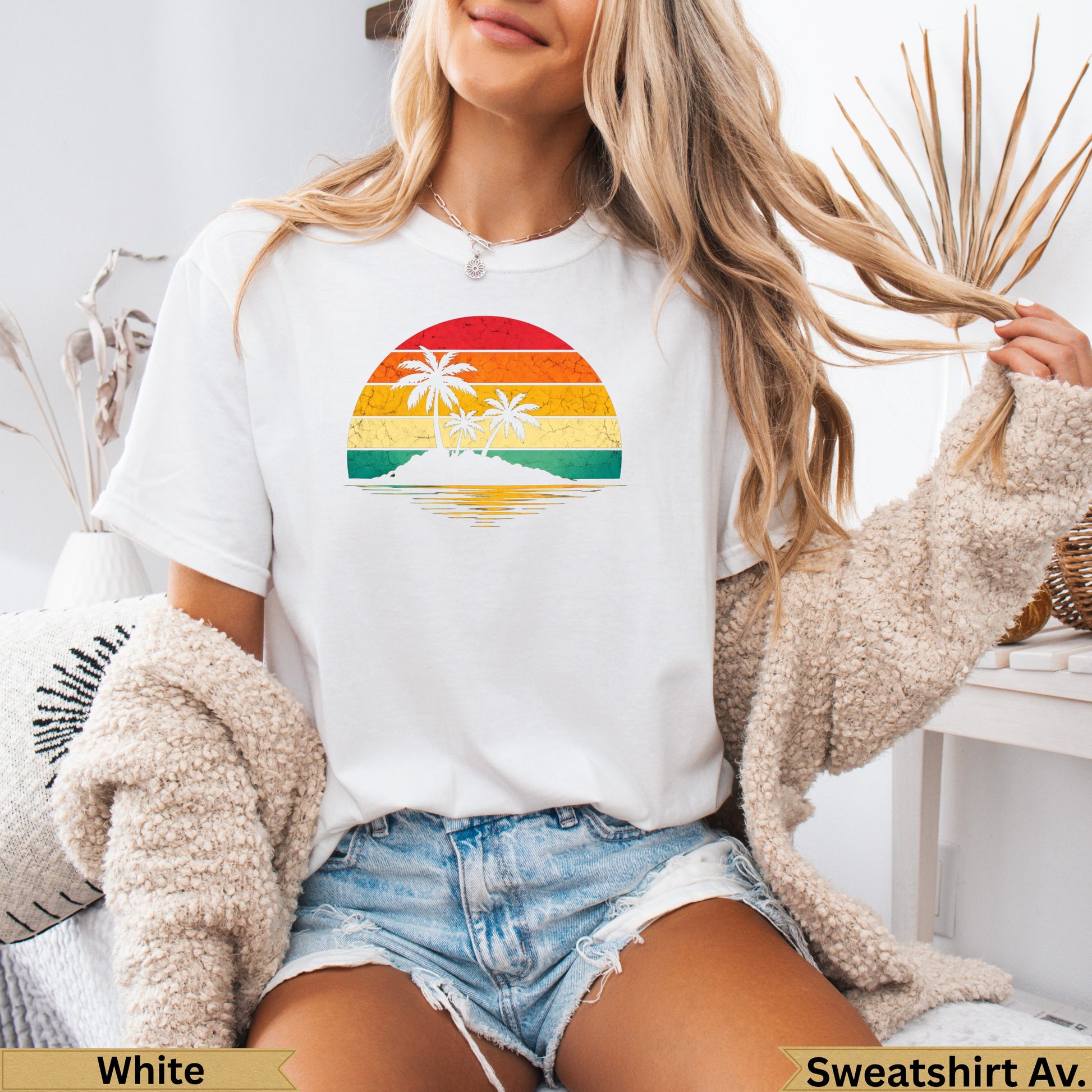 White t-shirt with retro sunset and palm trees graphic.