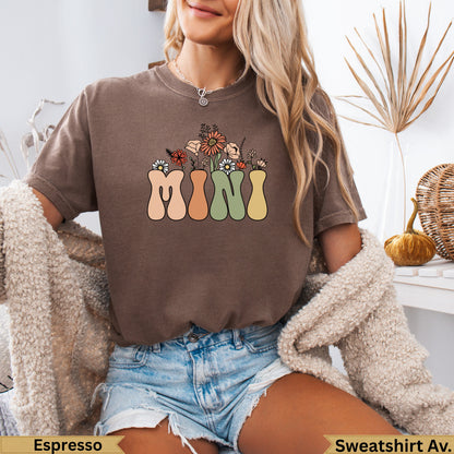 Brown t-shirt with "MINI" in colorful floral lettering across the chest.