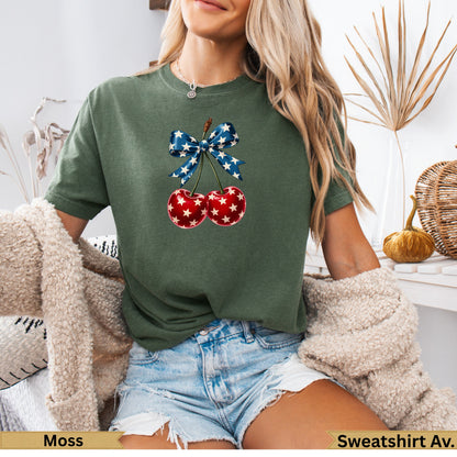 Green t-shirt with cherries adorned with a red, white, and blue star bow.