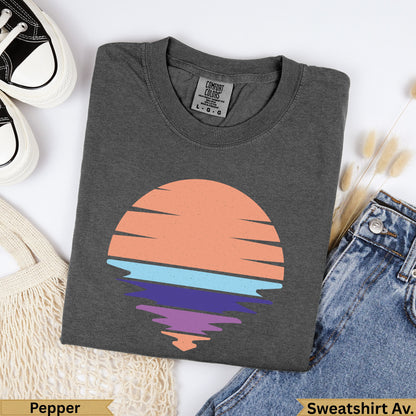 Dark gray Comfort Colors t-shirt with abstract sun and water graphic.