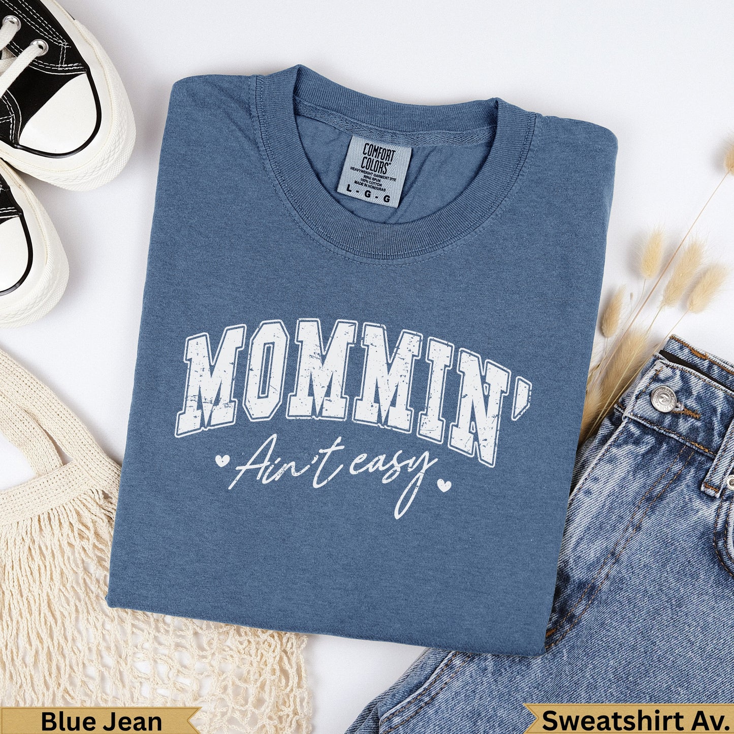 Blue jean colored sweatshirt with "Mommin' Ain't easy" graphic.