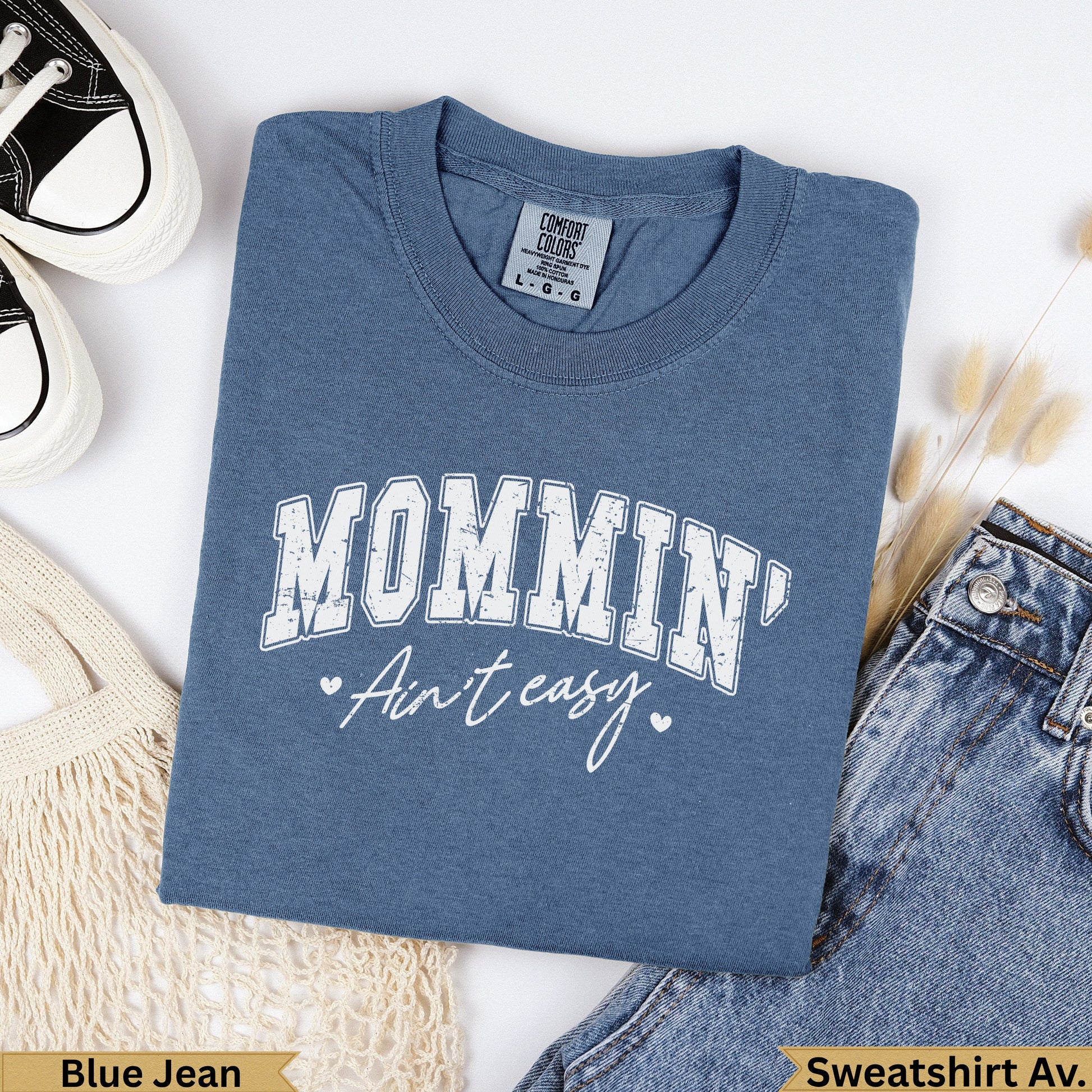 Blue jean colored sweatshirt with "Mommin' Ain't easy" graphic.