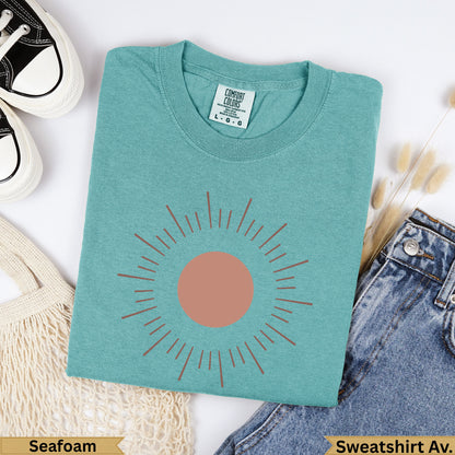 Seafoam Comfort Colors sweatshirt with a burnt orange sun graphic and "Seafoam" text.