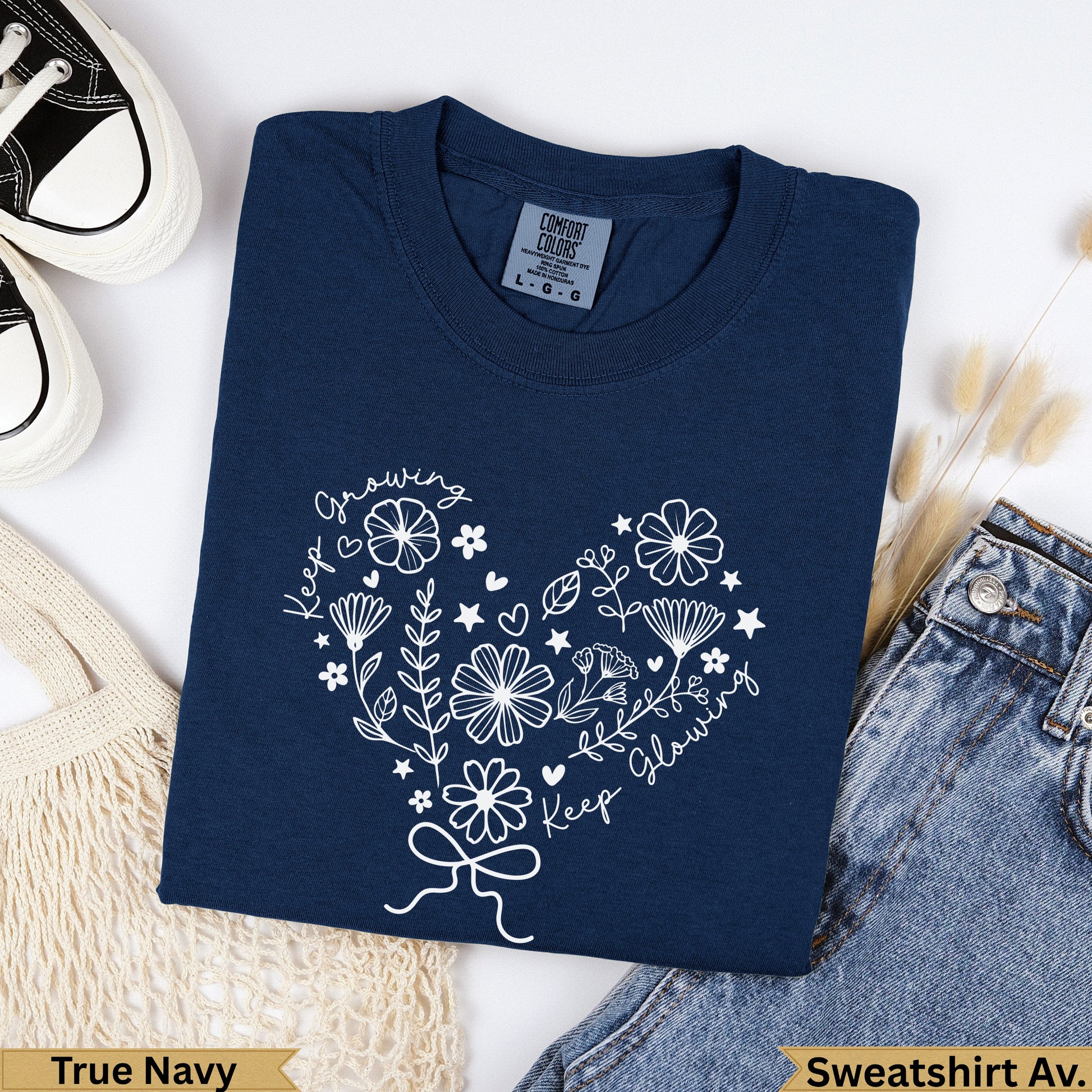 Navy Comfort Colors sweatshirt with heart floral graphic and "Keep Growing, Keep Glowing" text.
