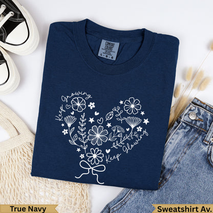 Navy Comfort Colors sweatshirt with heart floral graphic and "Keep Growing, Keep Glowing" text.