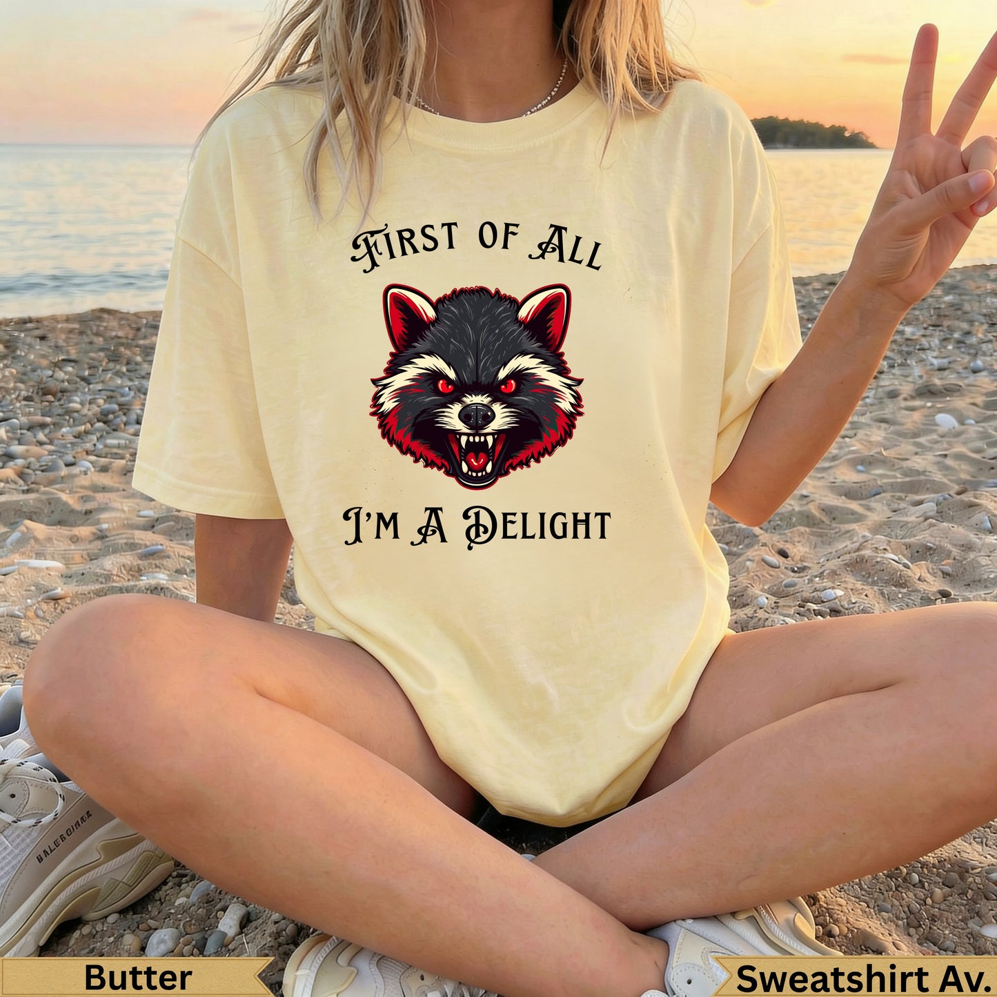 Yellow t-shirt with a raccoon graphic and text "First of all I'm a delight".