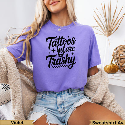 Purple t-shirt with "Tattoos are Trashy" graphic and checkered pattern.