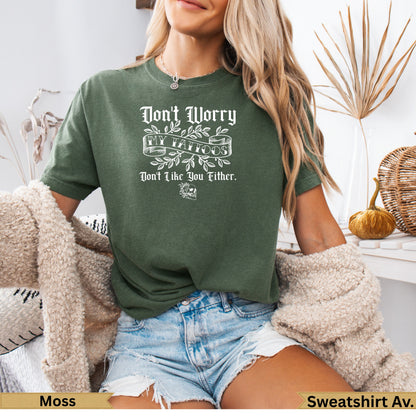 Green t-shirt with "Don't Worry, I'll Tattoo You" text and a ribbon graphic.