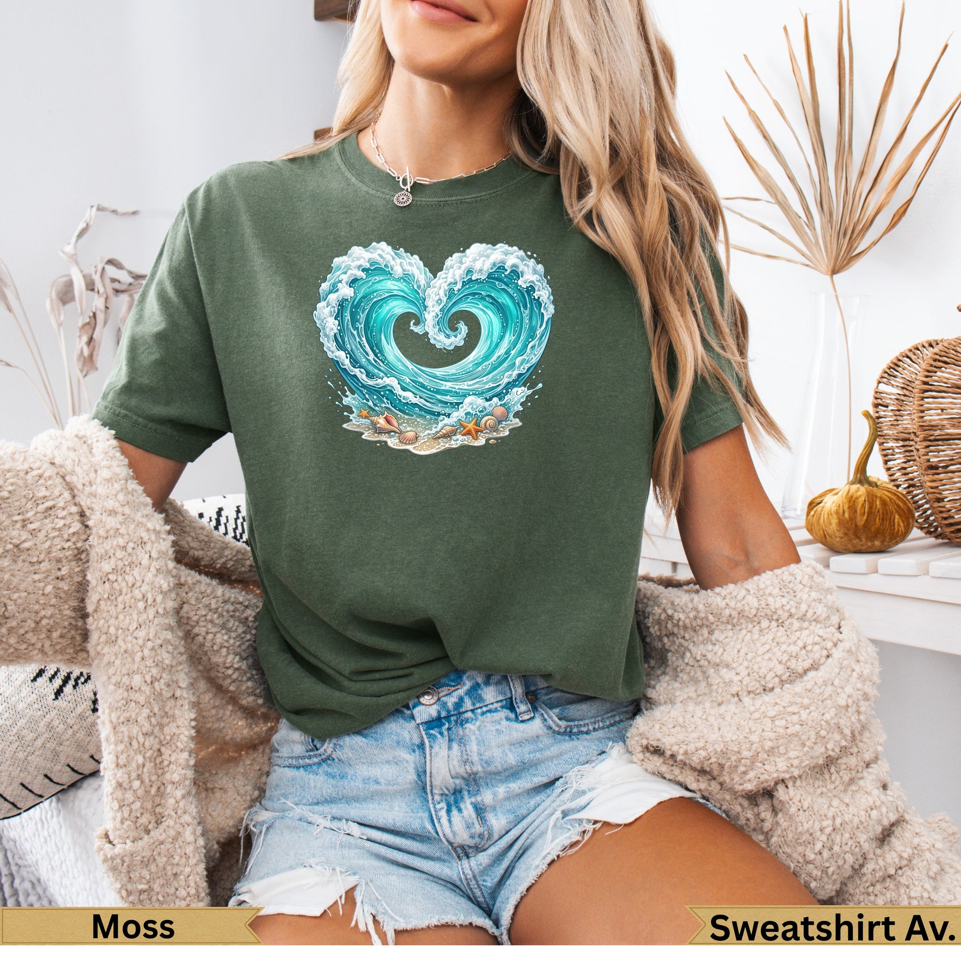Green t-shirt with heart-shaped wave graphic and seashells.