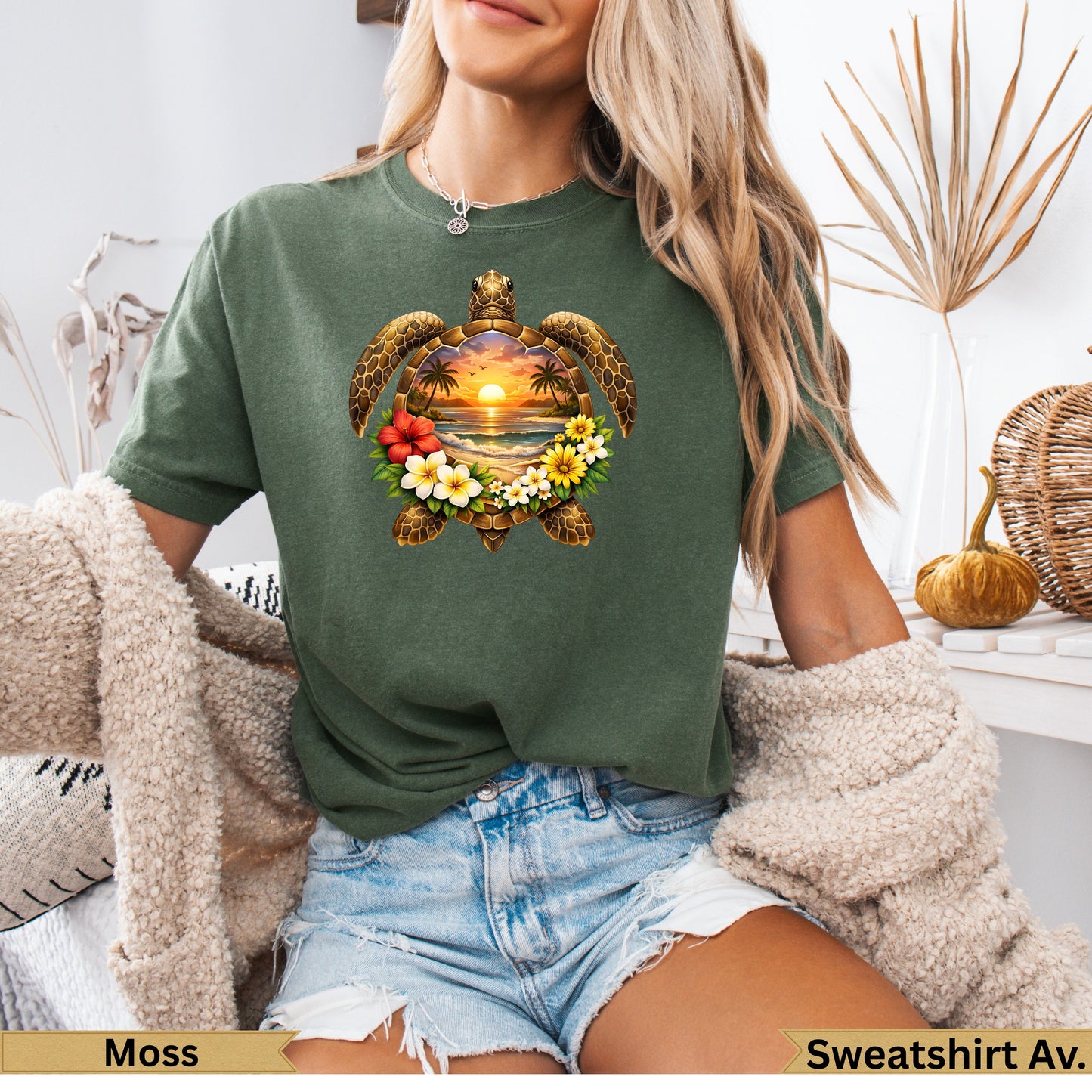 Green t-shirt with sea turtle, sunset, beach, and floral graphic.
