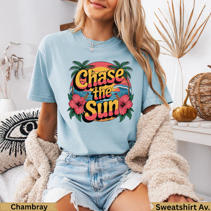 Light blue t-shirt with "Chase the Sun" text and tropical graphics.