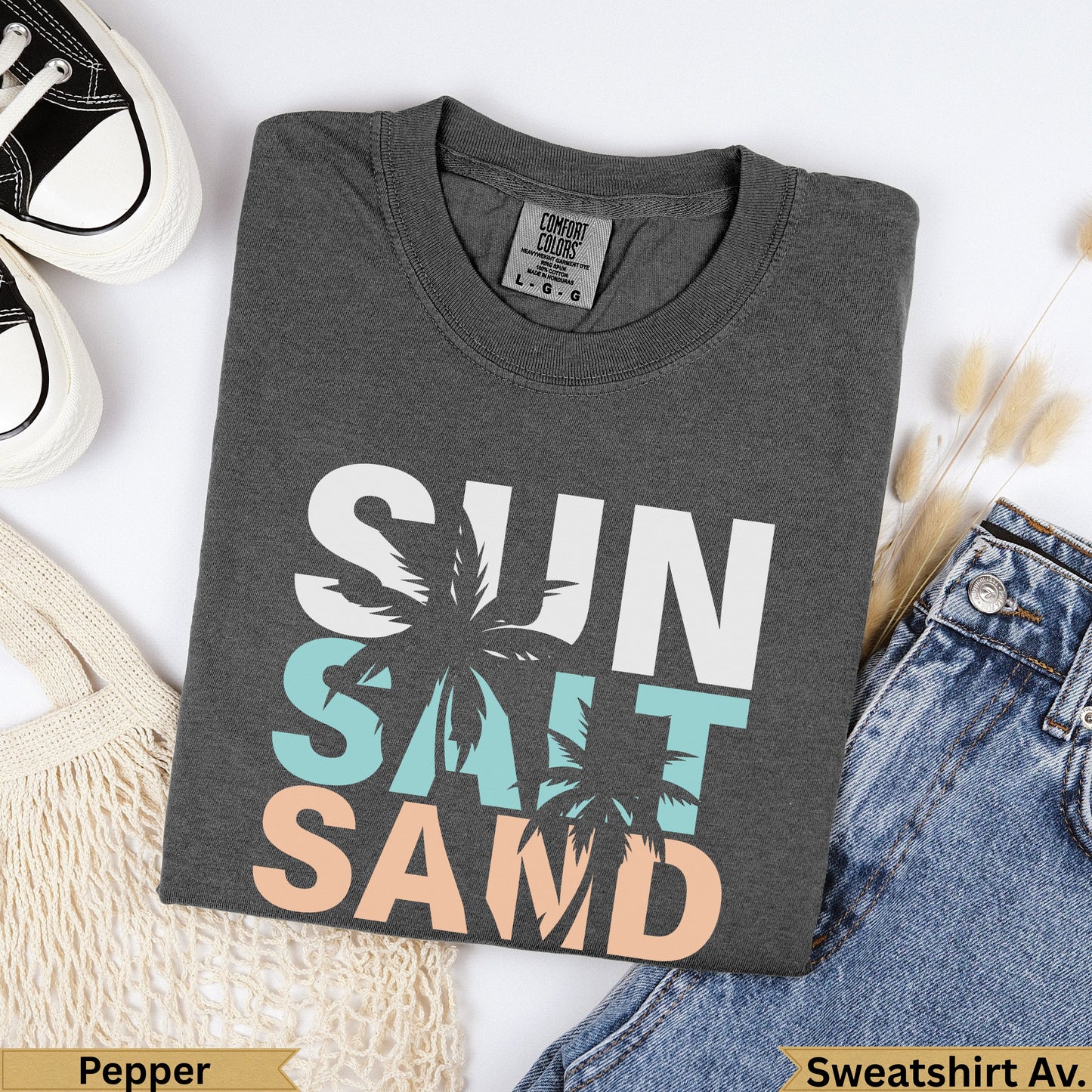 Dark grey t-shirt with "SUN SALT SAND" text, palm trees, and tags.