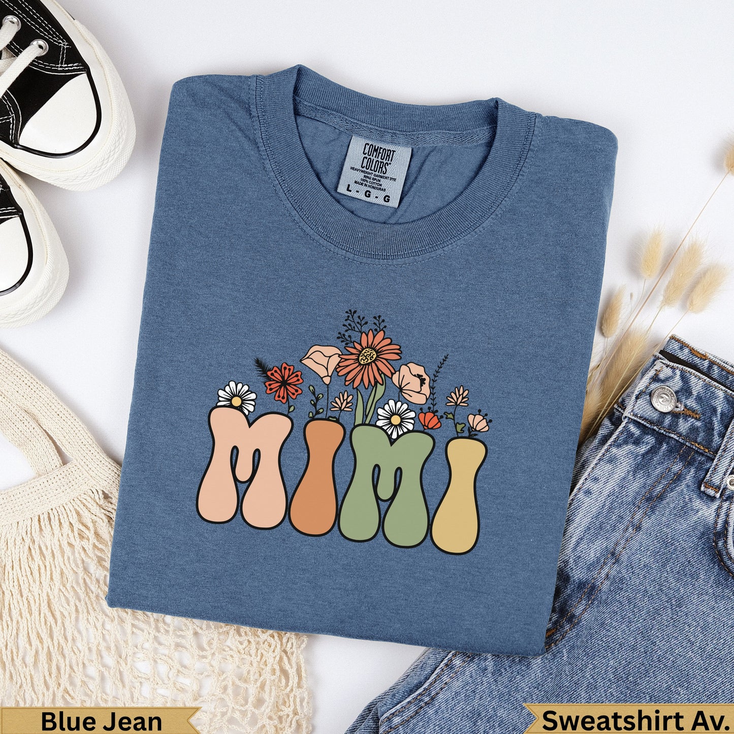 Blue denim sweatshirt with "Mimi" text and floral design.