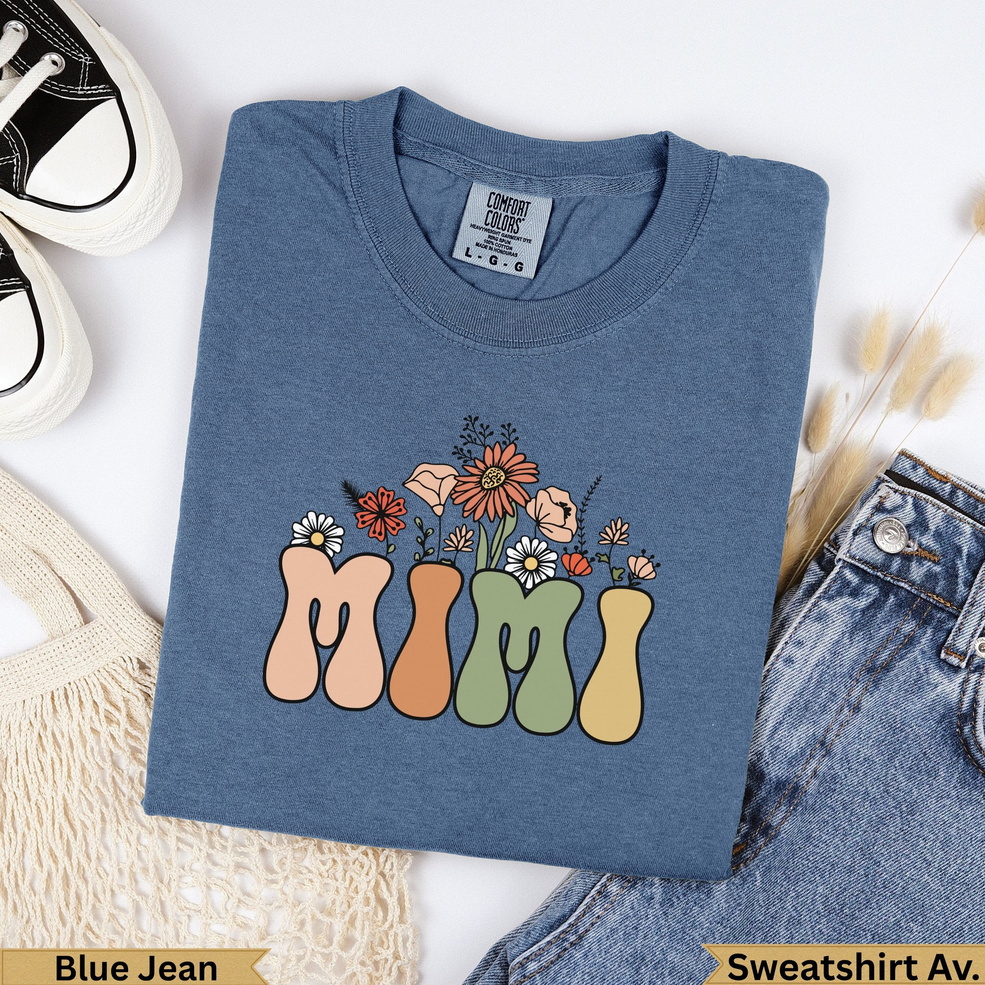 Blue denim sweatshirt with "Mimi" text and floral design.