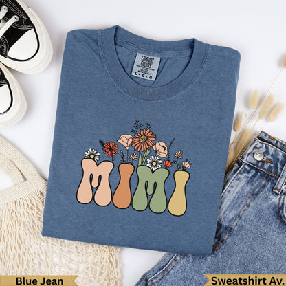 Blue denim sweatshirt with "Mimi" text and floral design.
