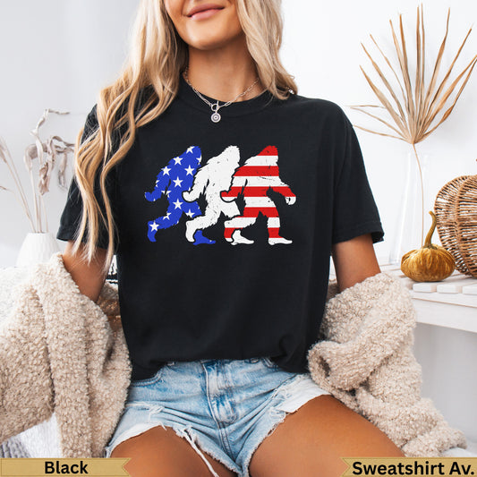 Bigfoot silhouettes in American flag patterns on a black t-shirt.