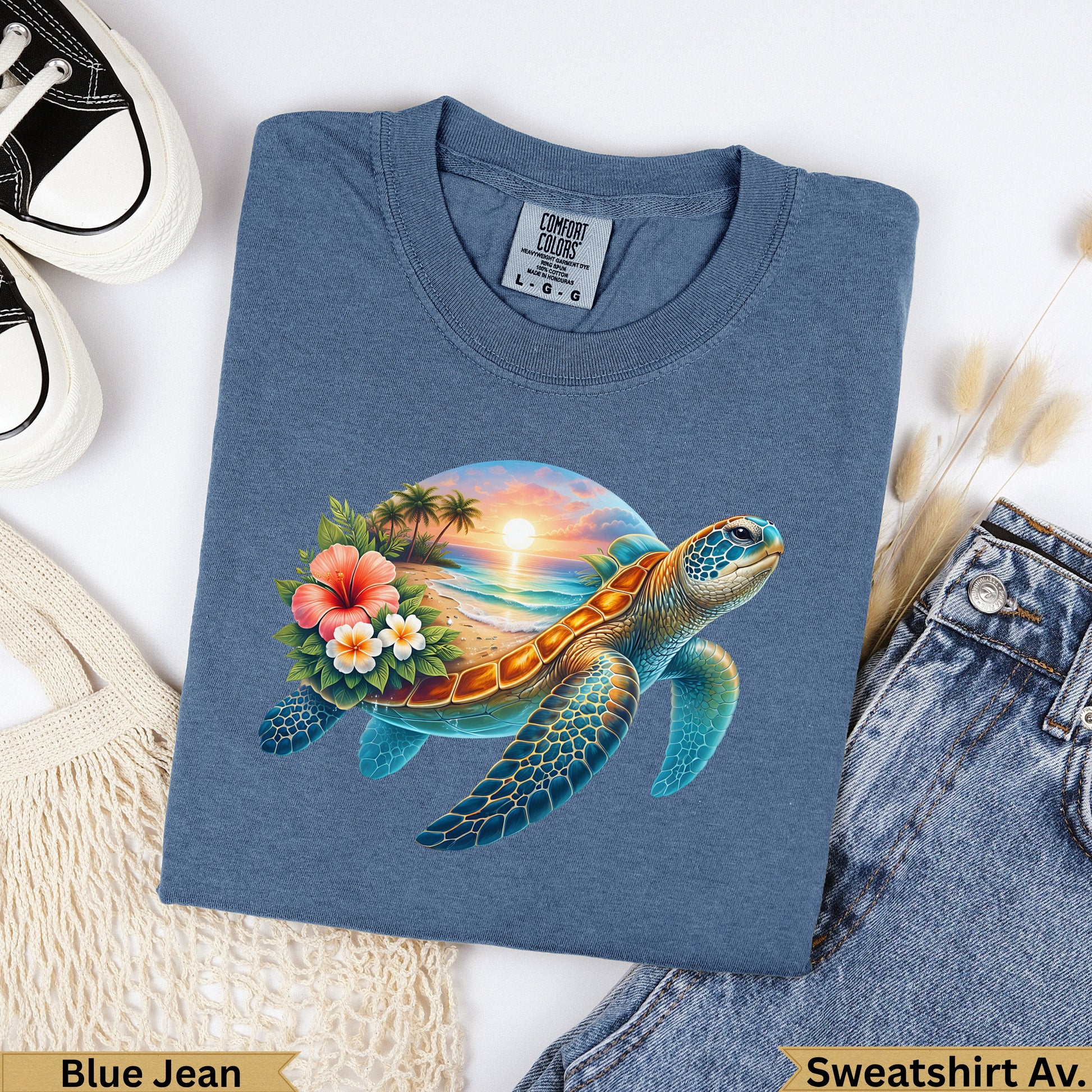 Blue t-shirt with a sunset beach scene and sea turtle graphic.