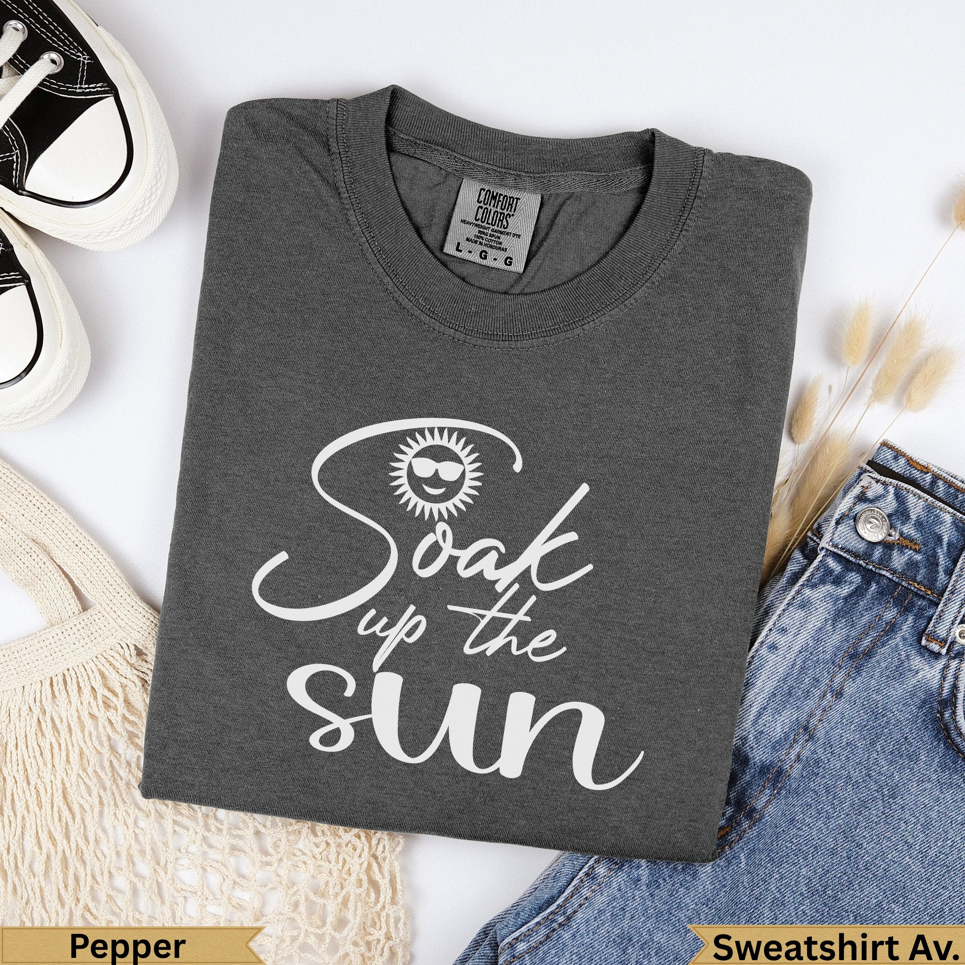 Dark gray "Soak up the sun" graphic t-shirt with sunglasses icon.