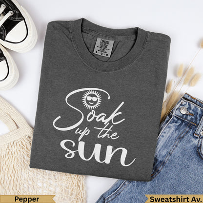 Dark gray "Soak up the sun" graphic t-shirt with sunglasses icon.