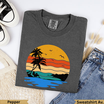 Dark gray crewneck sweatshirt with a vintage sunset beach graphic.