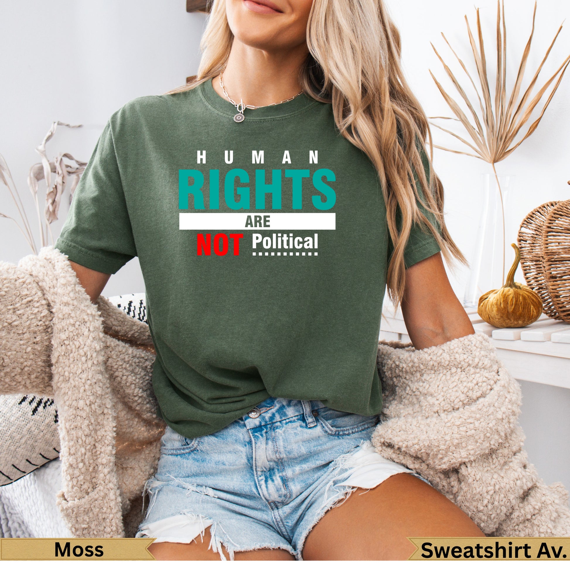 Green t-shirt with "Human Rights Are Not Political" text.
