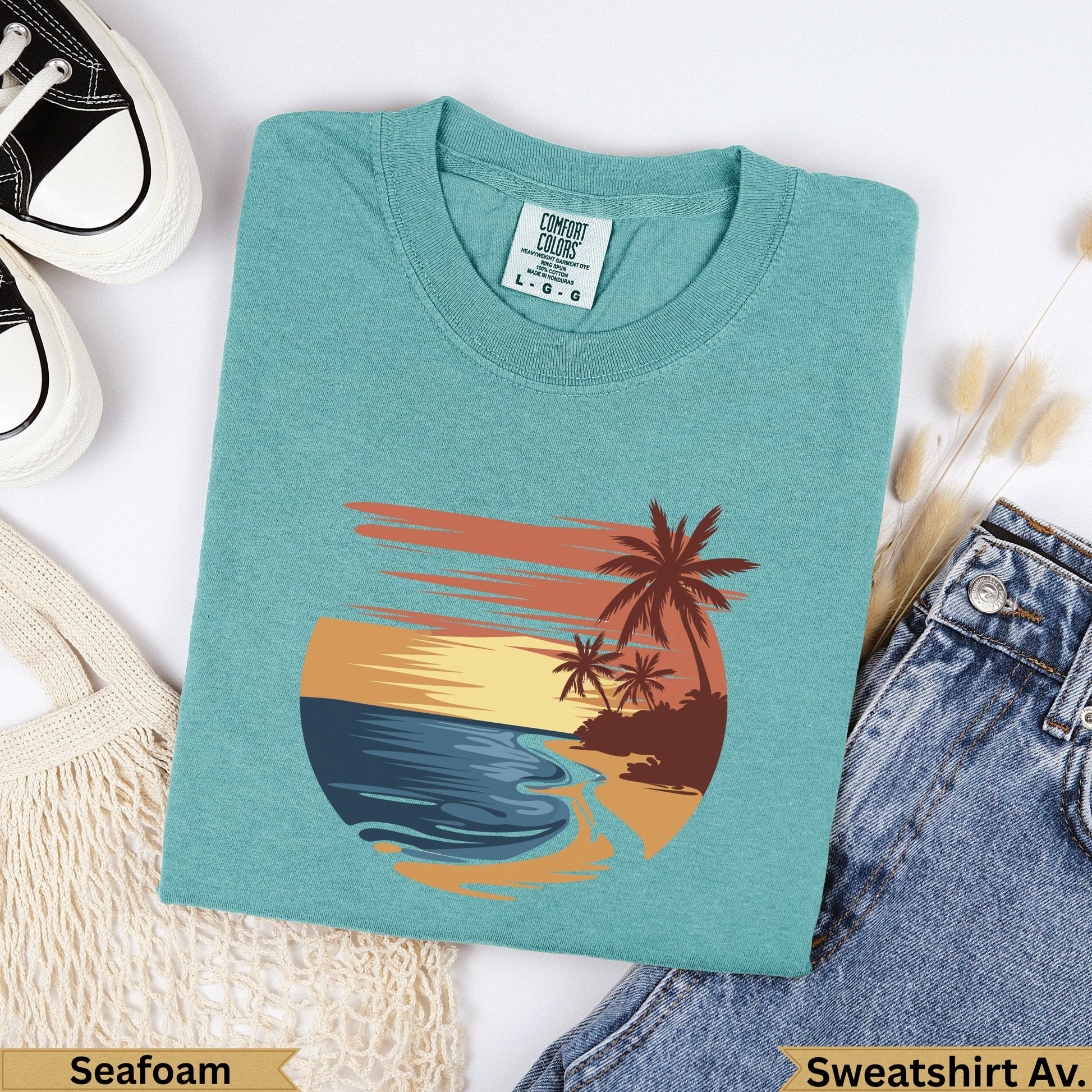 Teal t-shirt with sunset beach graphic, "Seafoam" and "Sweatshirt Av." text.