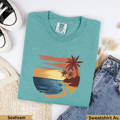 Teal t-shirt with sunset beach graphic, "Seafoam" and "Sweatshirt Av." text.