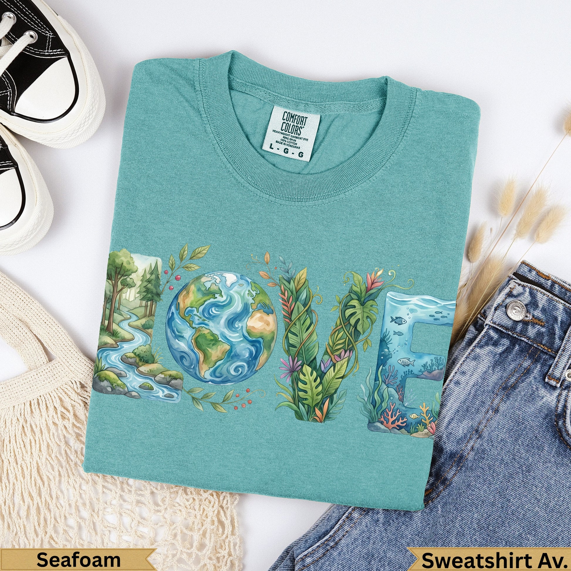 Green t-shirt with "LOVE" text incorporating Earth, plants, and ocean life.