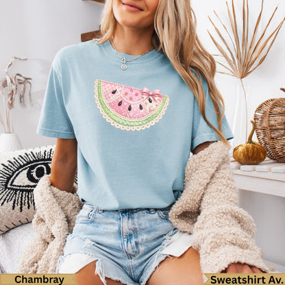 Light blue t-shirt with watermelon slice patch and pink bow.