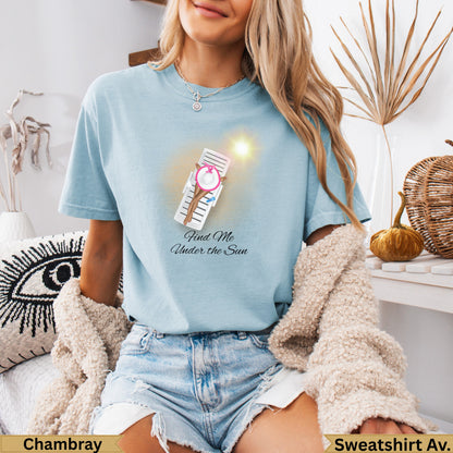 Light blue t-shirt with "Find Me Under the Sun" text and beach chair graphic.