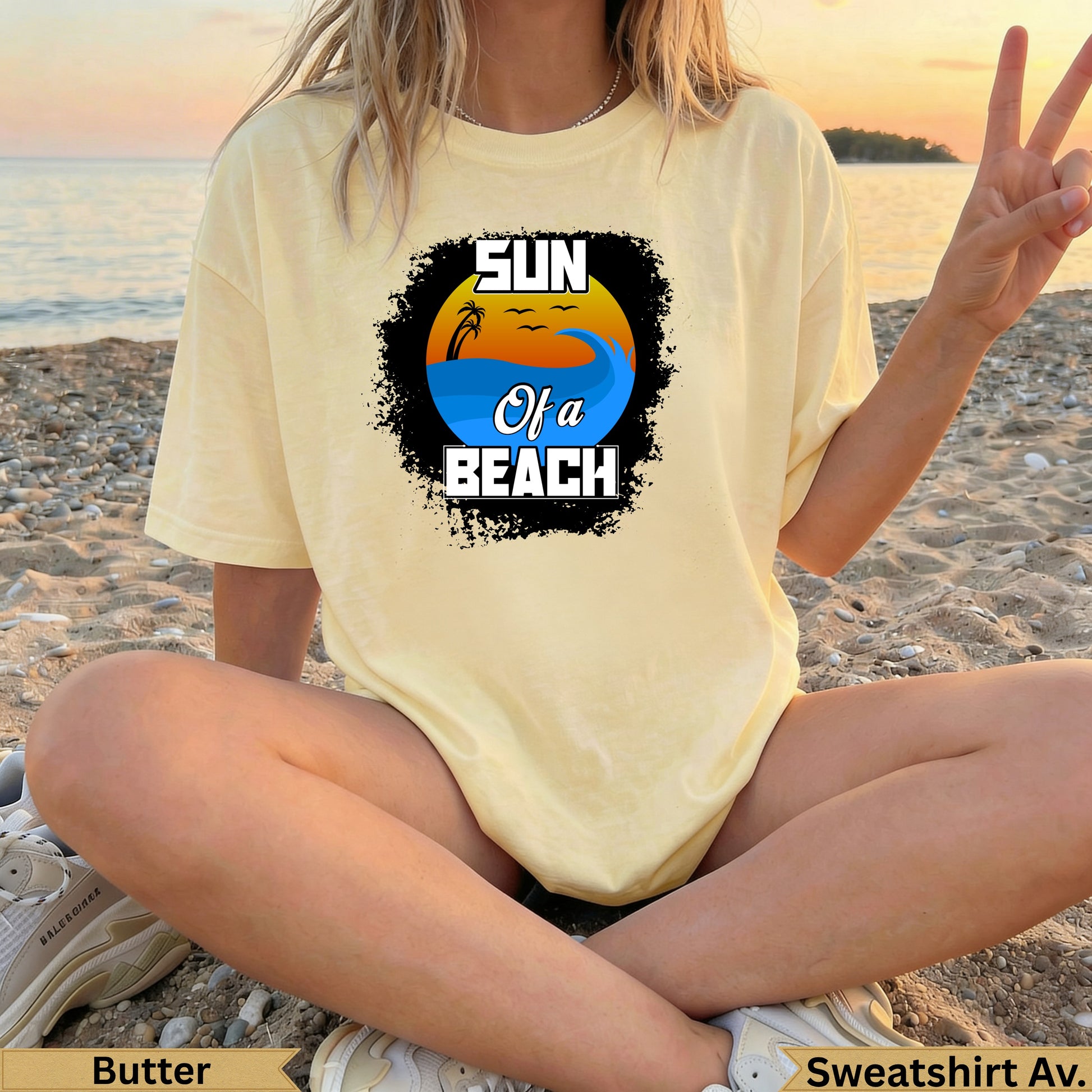 Light yellow t-shirt with "Sun of a Beach" graphic featuring waves and a sunset.