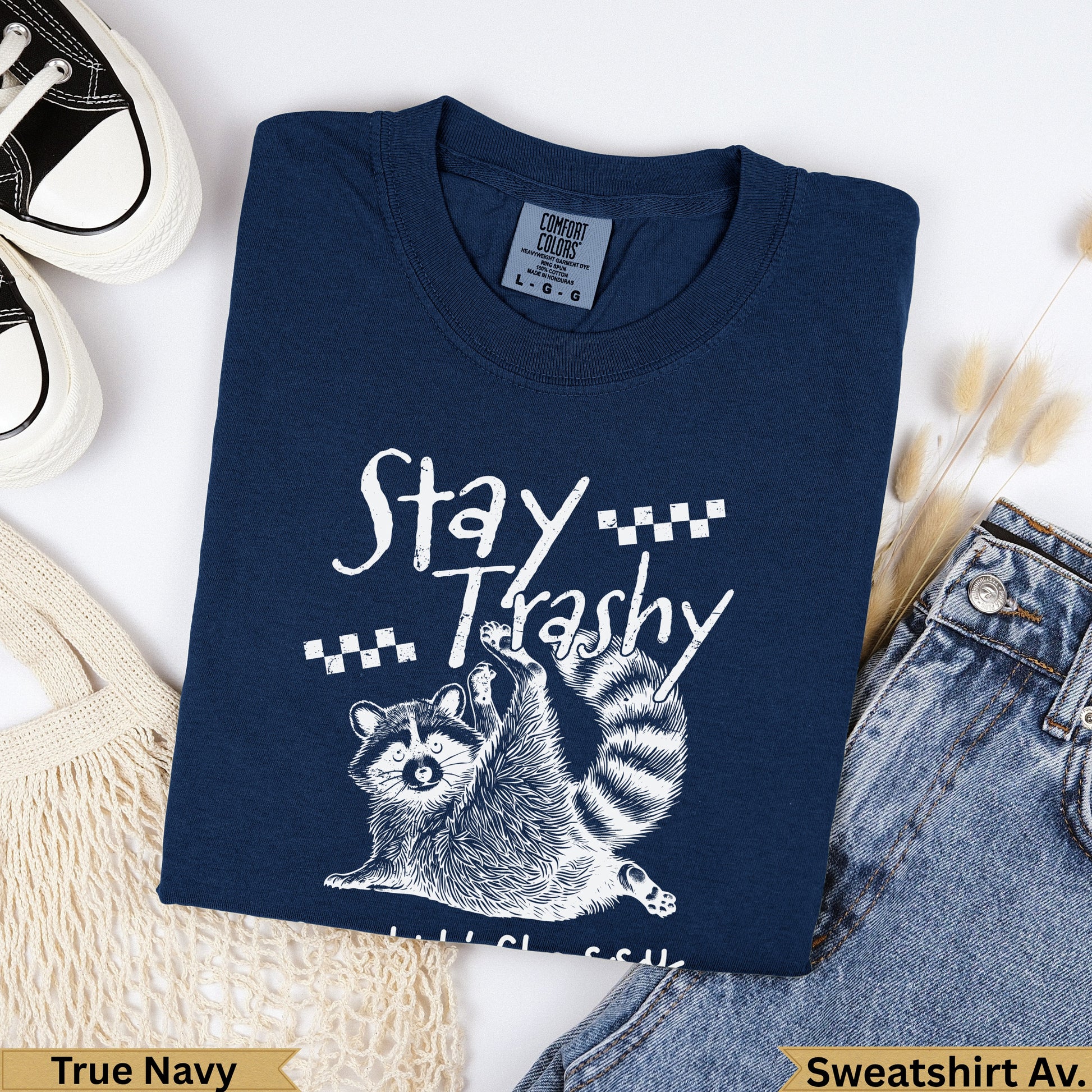 Navy t-shirt with "Stay Trashy" raccoon graphic and "True Navy" label.