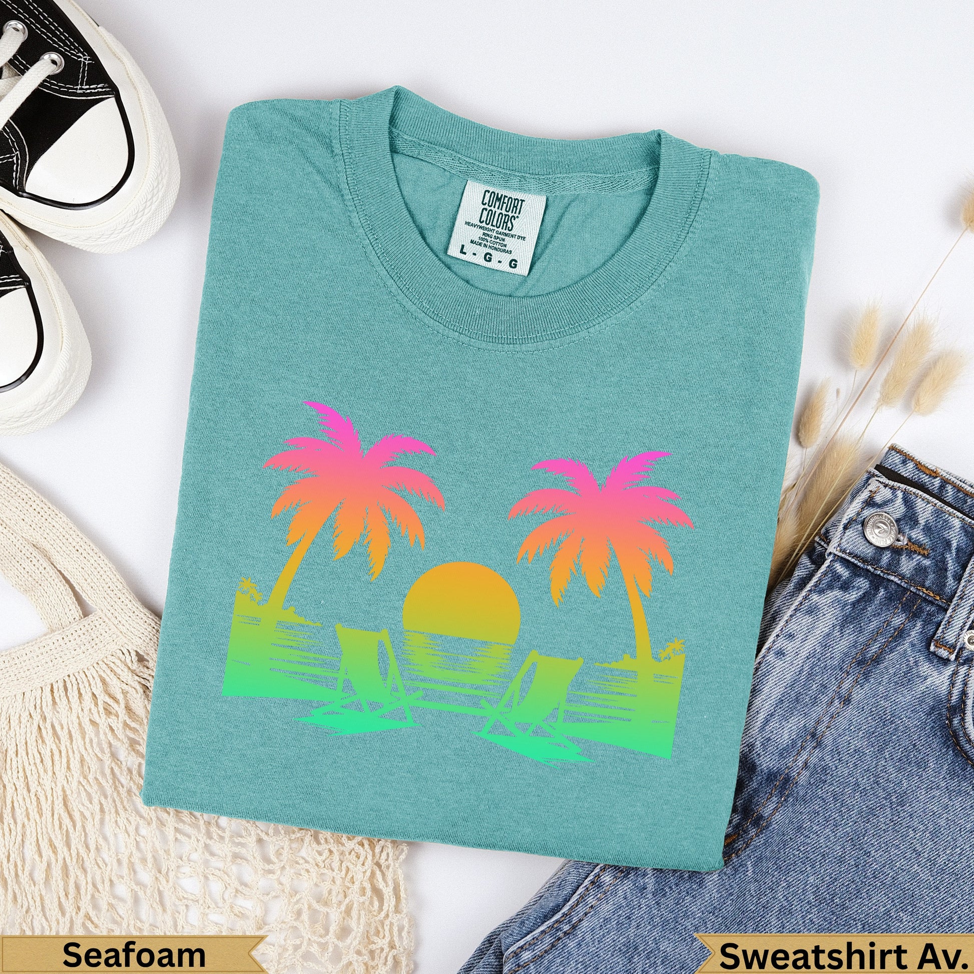 Teal Comfort Colors sweatshirt with a faded sunset and palm tree graphic.