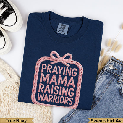 Navy t-shirt with "PRAYING MAMA RAISING WARRIORS" graphic.