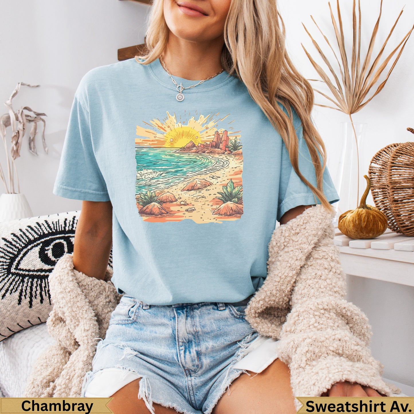 Light blue t-shirt with desert landscape sunset graphic.