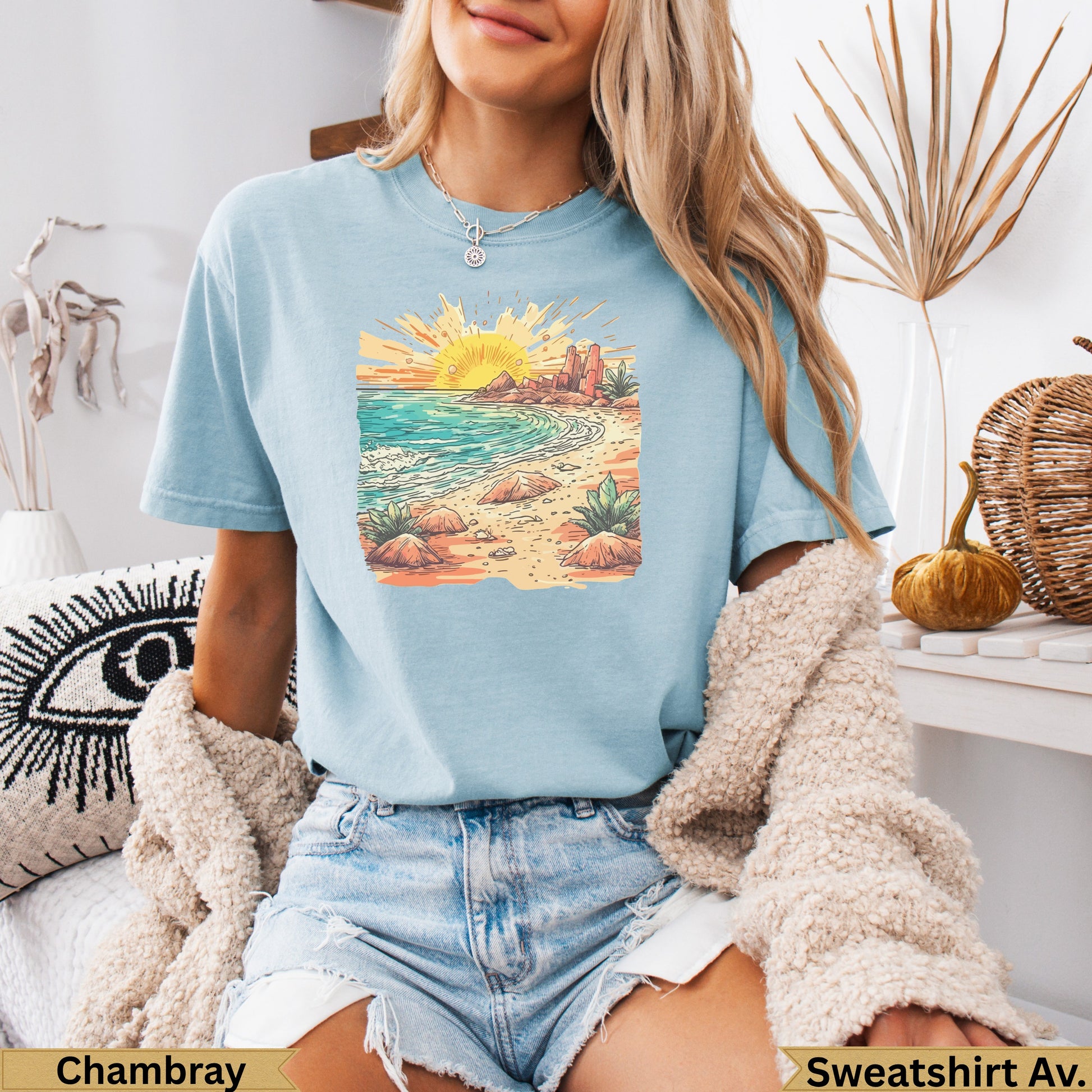 Light blue t-shirt with desert landscape sunset graphic.