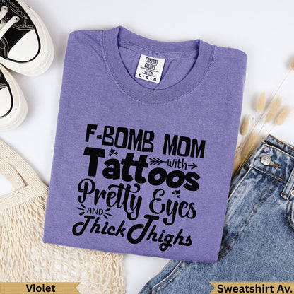 Purple Comfort Colors sweatshirt with "F-Bomb Mom" graphic and text.