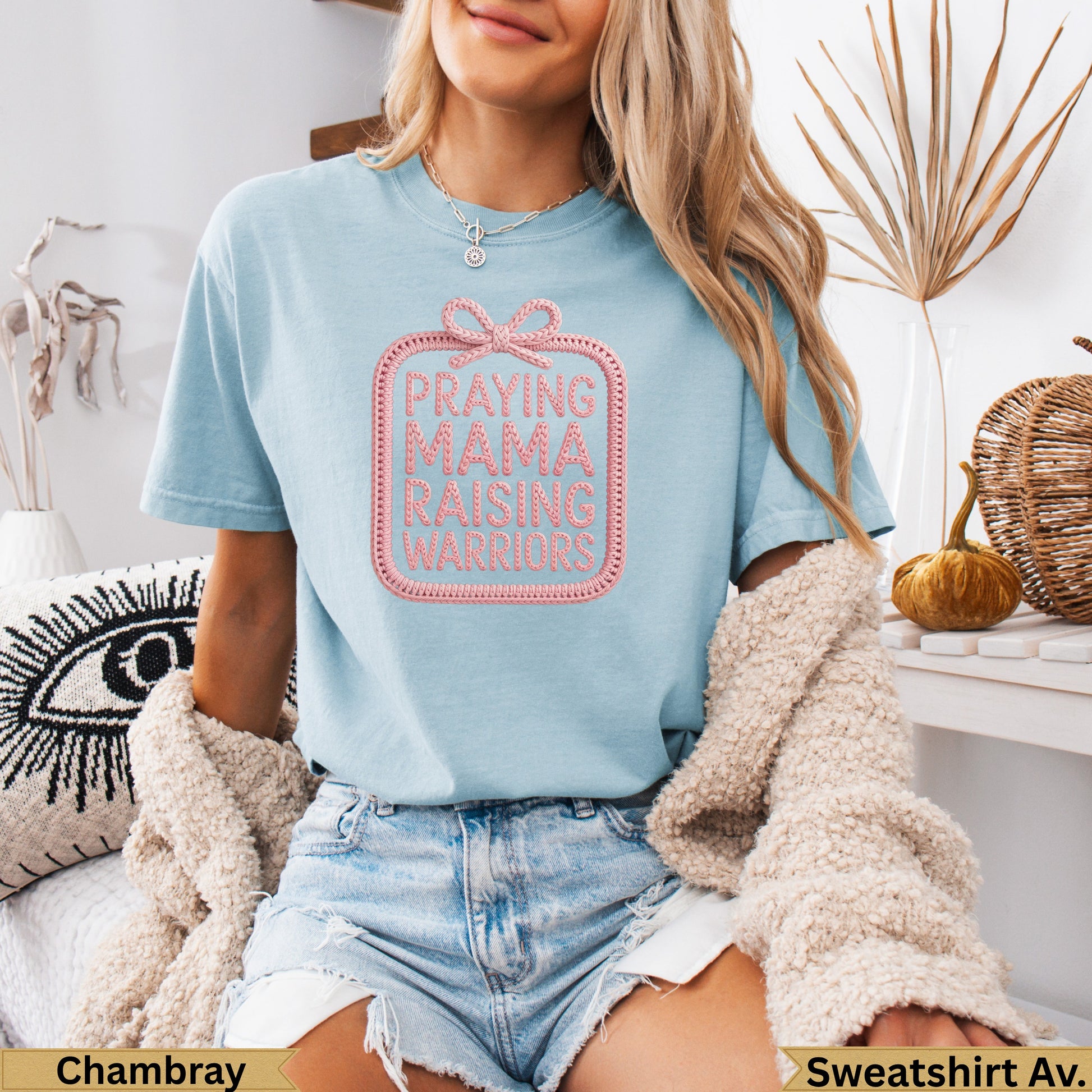 Light blue t-shirt with pink embroidered text "PRAYING MAMA RAISING WARRIORS."