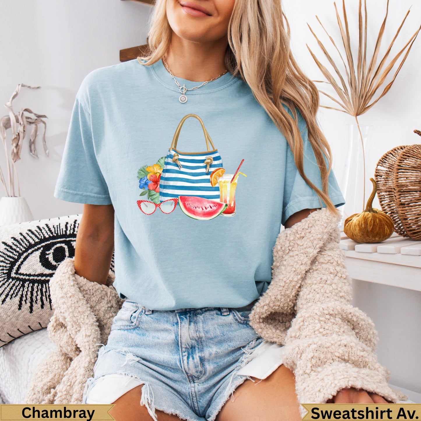 Light blue t-shirt with beach-themed graphic and "Chambray" and "Sweatshirt Av." text.