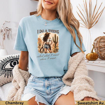 Light blue graphic t-shirt with desert scene and "I do a thing" text.