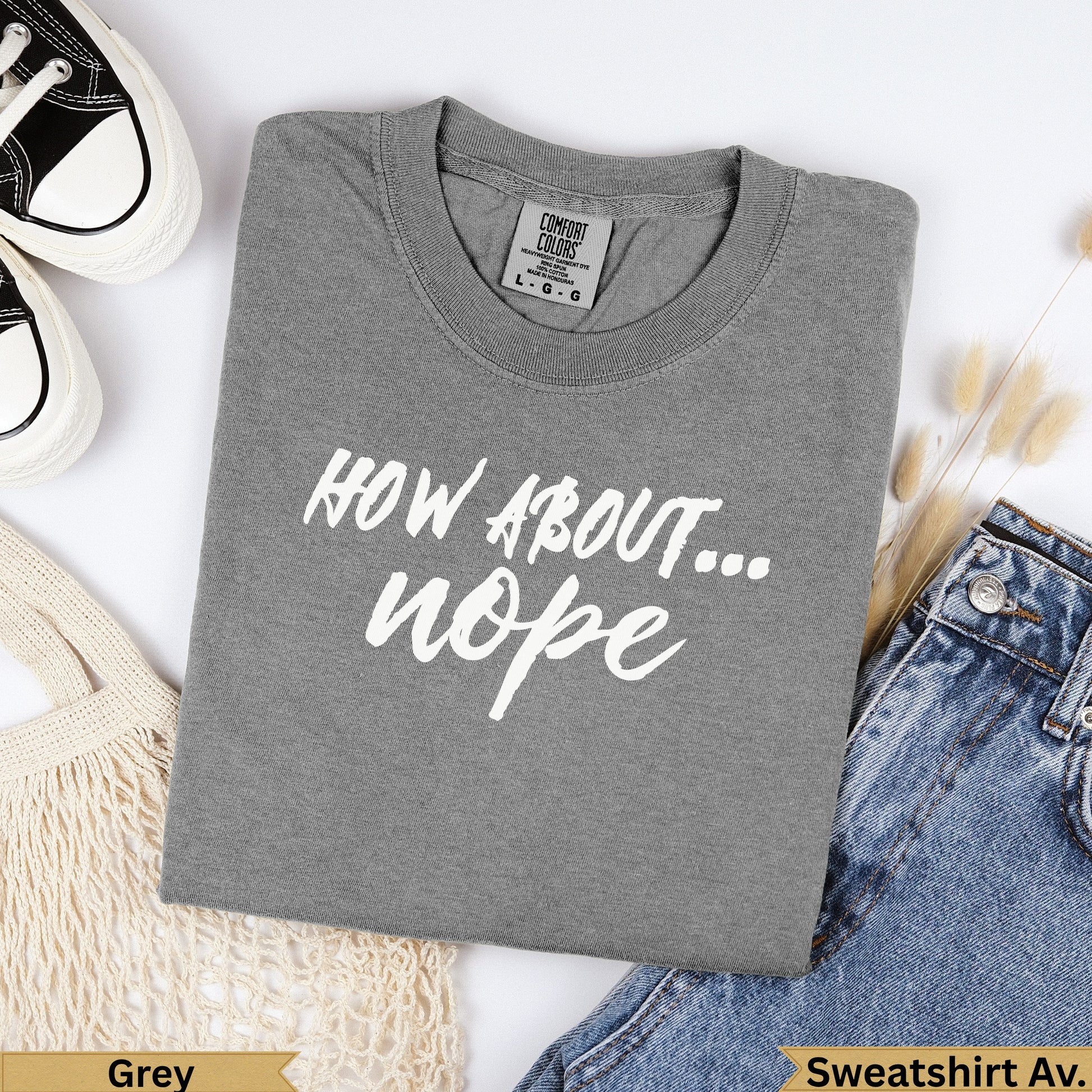 Grey crewneck sweatshirt with "HOW ABOUT... nope" text and denim.