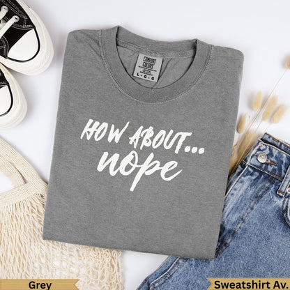 Grey crewneck sweatshirt with "HOW ABOUT... nope" text and denim.