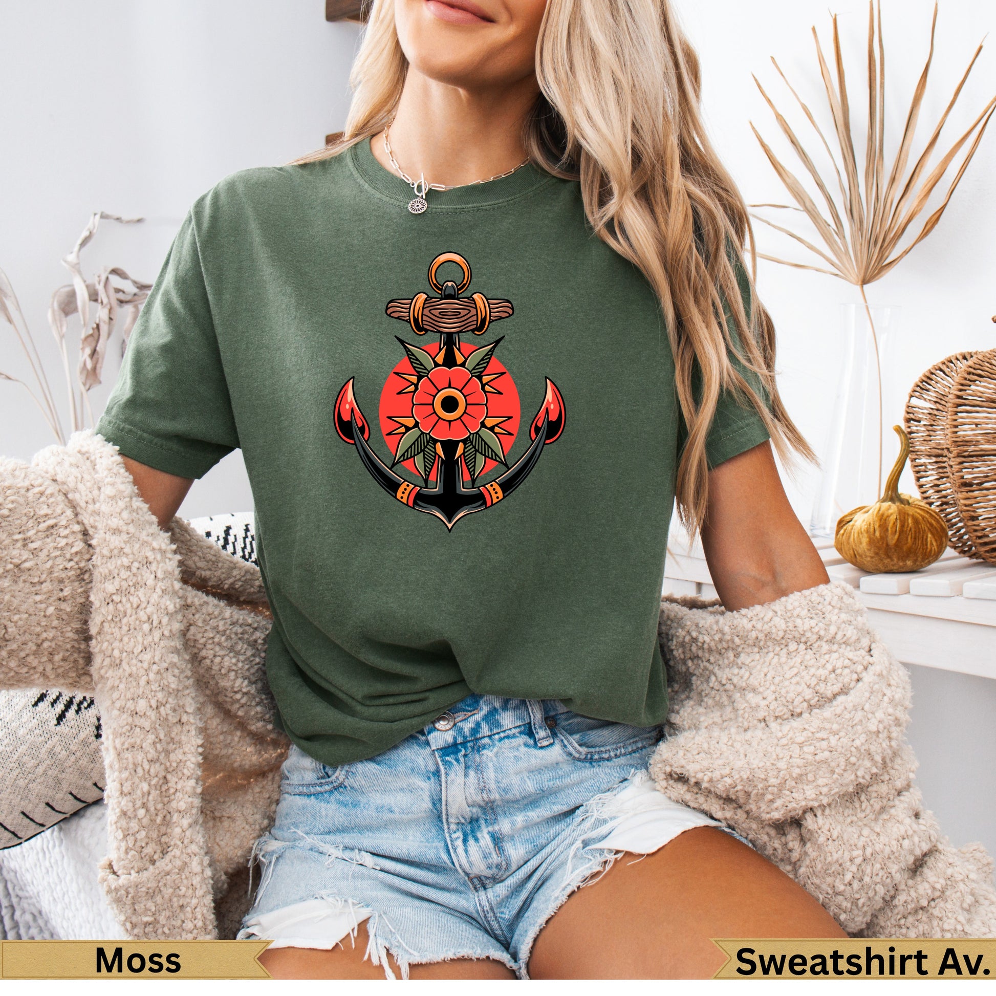 Anchor and sun tattoo design on olive green t-shirt.