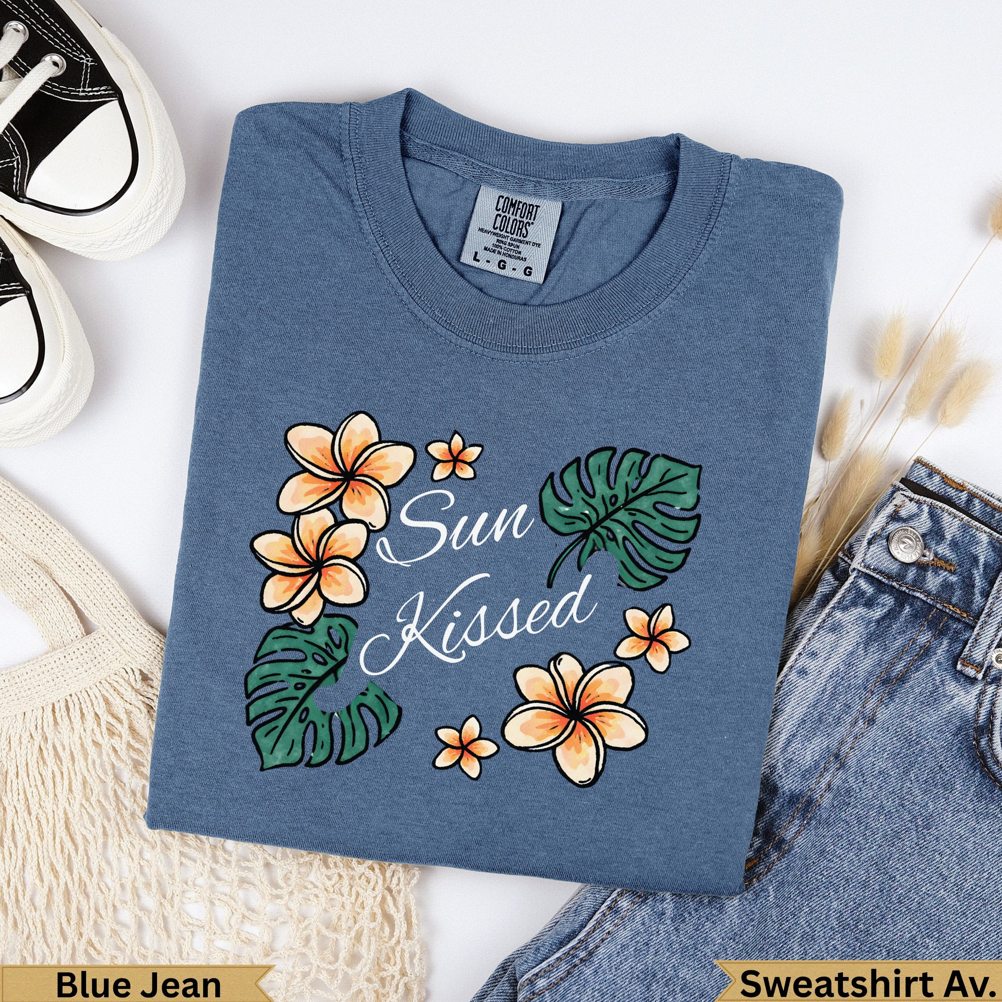 Blue t-shirt with "Sun Kissed" text and floral design.